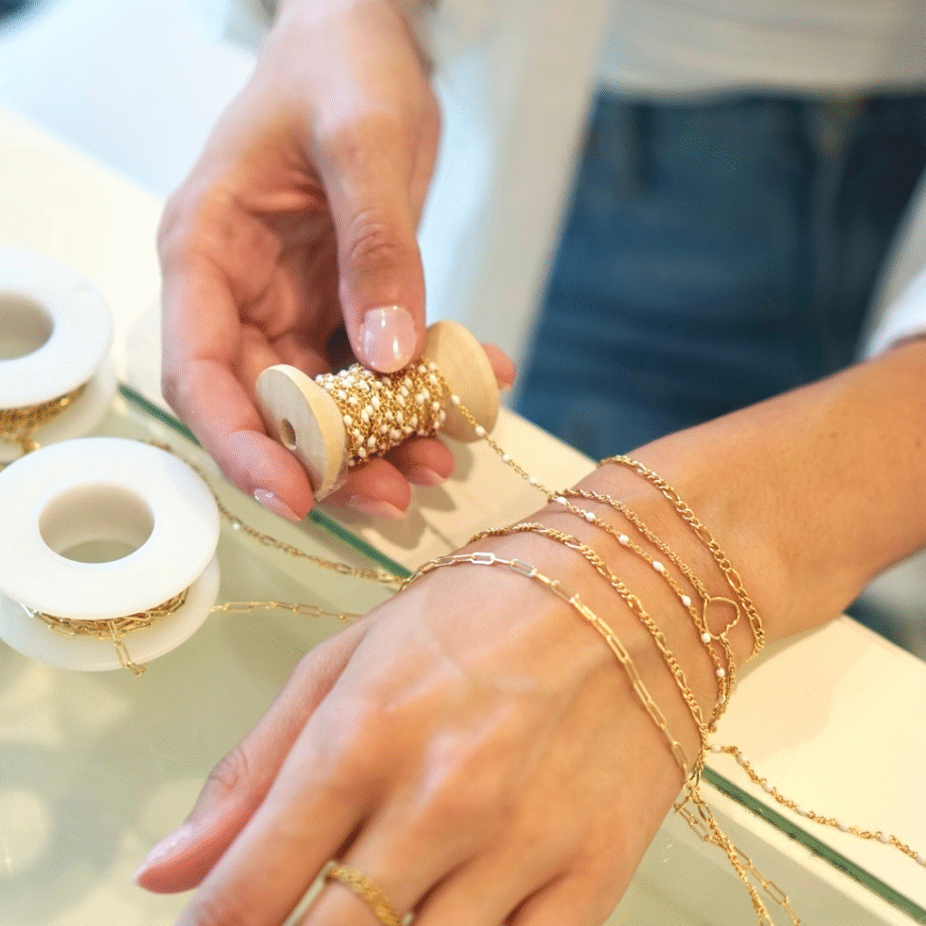 Artist measuring a customer's wrist for a custom-fit bracelet.
